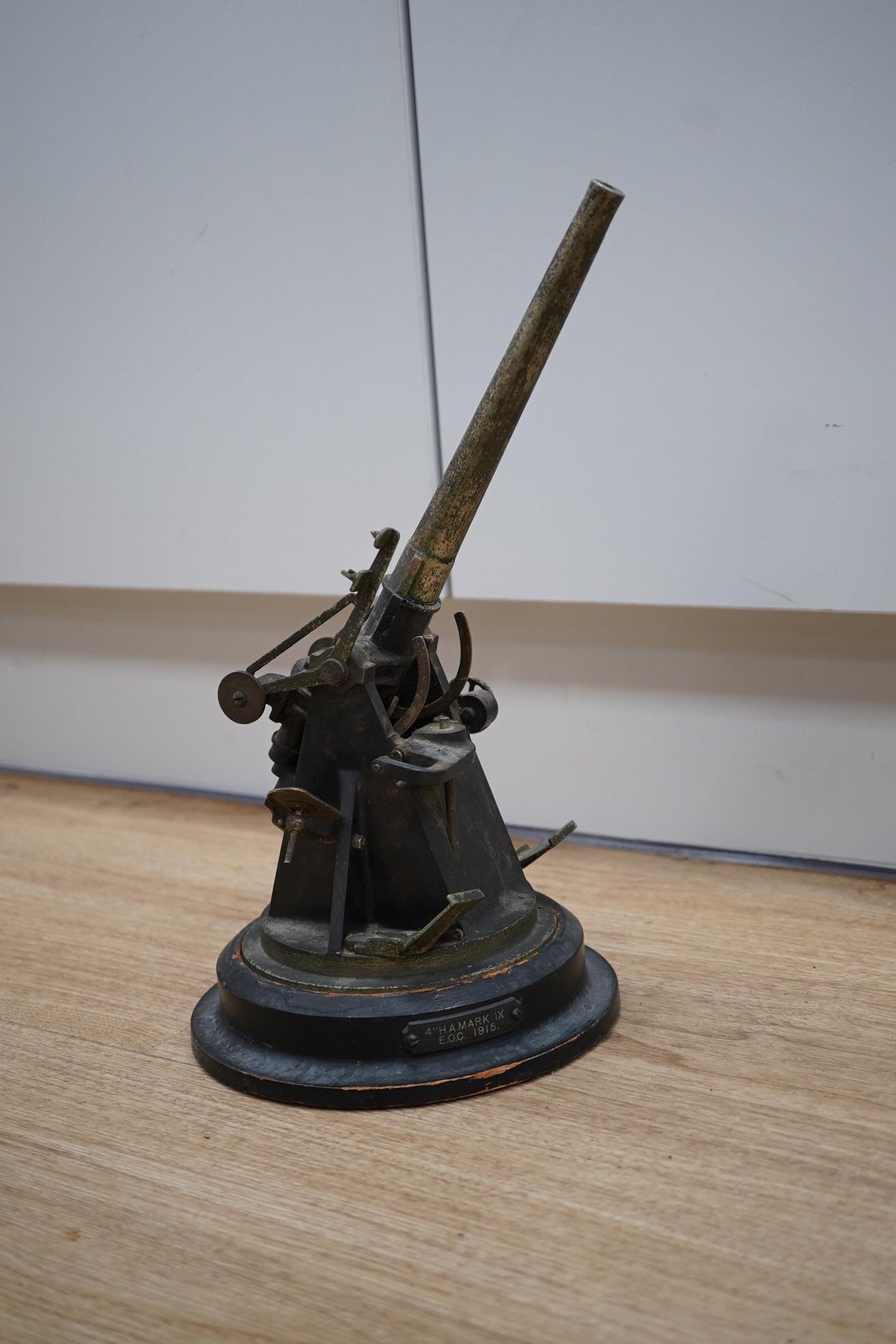 A steel model of a First World War 4 inch mark IX E.O.C. anti-aircraft gun, barrel 18cm, on a turned ebonised pine base with applied label. Condition - fair, some wear overall.